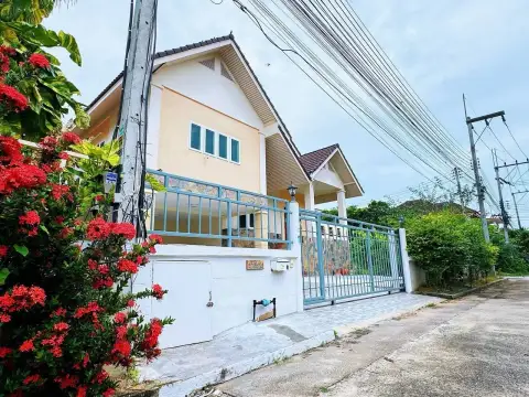 4 Bedroom House for Rent at Park Hill Village front gate entrance with blue railing and tropical flowers