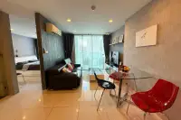 1 Bedroom Condo for Sale at Park Royal 3 open-plan living and dining area with glass table and bedroom view