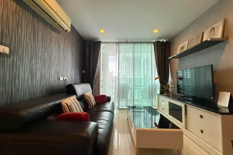 1 Bedroom Condo for Sale at Park Royal 3 cozy living room with dark sofa, TV cabinet, and city view