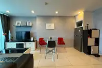 1 Bedroom Condo for Sale at Park Royal 3 dining area with red chairs, TV, and kitchen fridge