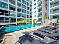 1 Bedroom Condo for Rent at Park Royal 3 outdoor pool deck with lounge chairs and tower view
