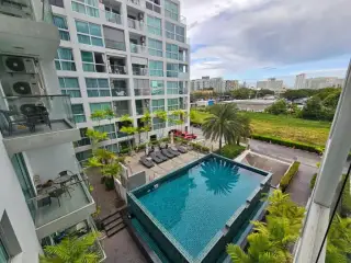 Park Royal 3 rooftop swimming pool with wooden siding, overlooking the city skyline and ocean.