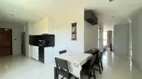 2 Bedroom Condo for Rent at Park Royal 3 kitchen with white cabinets, black countertop, and dining table