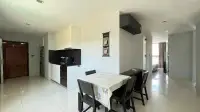 2 Bedroom Condo for Rent at Park Royal 3 dining area with black chairs, kitchen, and hallway view to bedroom