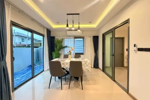 3 Bedroom House for Rent at Patta Define dining area with table, chairs, and sliding glass doors to garden