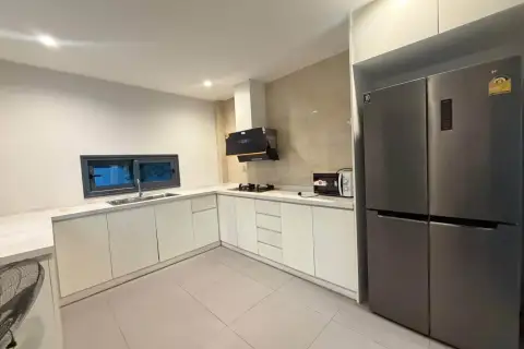 3 Bedroom House for Rent at Patta Define modern kitchen with white cabinetry and stainless steel refrigerator