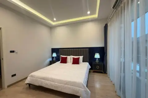 3 Bedroom House for Rent at Patta Define master bedroom with upholstered headboard and red accent pillows