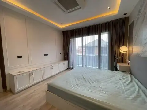 3 Bedroom House for Rent at Patta Define two-story modern house exterior with gated driveway and entrance sign