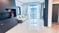 3 Bedroom House for Rent at Patta Define living room with sofa, glossy tiles, and balcony view