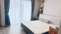 3 Bedroom House for Rent at Patta Define bedroom with white bed, sheer curtains, and floral wall art