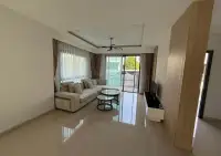 3 Bedroom House for Sale at Patta Define bright living room with beige sectional sofa and sliding glass doors