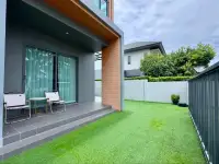 4 Bedroom House for Sale at Patta Define side garden with artificial grass and outdoor folding chairs