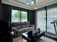 4 Bedroom House for Sale at Patta Define living room with grey sofa and large windows