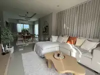 3 Bedroom House for Rent at Patta Element living room with white sectional sofa and dining area view