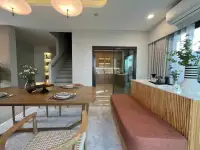 3 Bedroom House for Rent at Patta Element dining space with wooden table and built-in orange bench seating