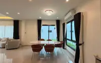 4 Bedroom House for Rent at Patta Element open-plan dining area with marble table and garden view windows