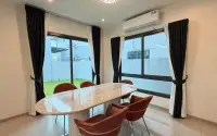 4 Bedroom House for Rent at Patta Element dining nook with oval marble table, rust-colored chairs and large windows