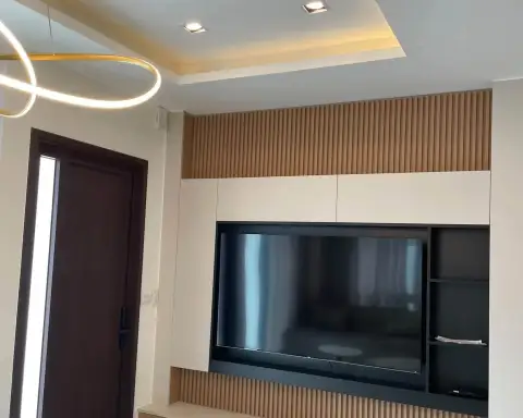 4 Bedroom House for Rent at Patta Element wall-mounted TV with wood slat paneling
