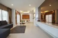 3 Bedroom House for Rent at Patta Prime open-plan living and dining area with mirrored wall accent
