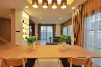 3 Bedroom House for Rent at Patta Prime wooden dining table set overlooking living room and balcony