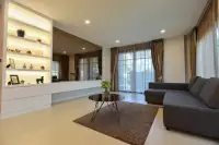 3 Bedroom House for Rent at Patta Prime living room with gray sectional sofa and built-in display shelving
