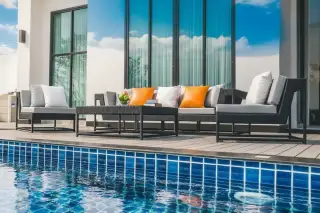 Patta Prime outdoor patio with comfortable lounge seating next to a private swimming pool.