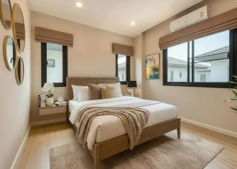 3 Bedroom House for Rent at Patta Ville cozy bedroom with wooden bed and round mirror decor