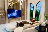 5 Bedroom House for Sale in Mabprachan spacious living area with curved sofa large TV and arched garden windows