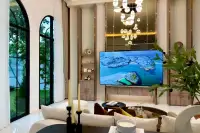5 Bedroom House for Sale in Mabprachan elegant living room with high ceiling chandelier and large arched window