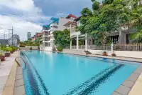 8 Bedroom House for Sale in Pratumnak Hill spacious lap pool with lush tropical trees and multi-storey house exterior