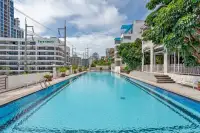 8 Bedroom House for Sale in Pratumnak Hill long lap pool with poolside sun loungers flanked by the house and Tara Court