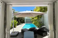 3 Bedroom House for Sale in Huai Yai covered patio lounge area with umbrella overlooking pool