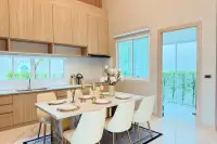 3 Bedroom House for Rent at Narita Villa dining area with marble table and kitchen counter view