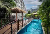 1 Bedroom Condo for Sale at Laguna Beach Resort 3 (The Maldives) wooden walkway and thatched-roof gazebos over swimming pool