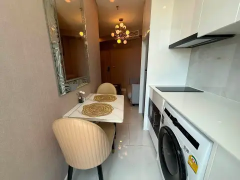 1 Bedroom Condo for Sale at Copacabana Beach Jomtien dining nook with kitchen counter and washing machine