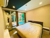 1 Bedroom Condo for Sale at Seven Seas Condo Resort bedroom with mirrored wardrobe and pool view through curtains