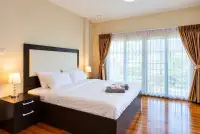 4 Bedroom House for Sale at Central Park Hillside spacious master bedroom with large bed and garden-view windows