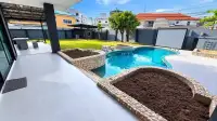 2 Bedroom House for Sale at Thanyawan Home curved swimming pool with stone edging and covered patio