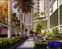 3 Bedroom Condo for Sale at The Riviera Malibu landscaped walkway with palm trees and lush green vertical garden