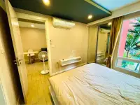 1 Bedroom Condo for Sale at Seven Seas Condo Resort bedroom with open door to dining area and standing fan