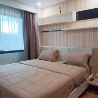 1 Bedroom Condo for Sale in Jomtien bedroom with upholstered headboard, striped wallpaper and sheer curtains
