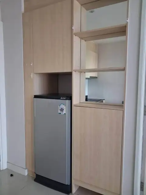 1 Bedroom Condo for Sale at Grande Caribbean built-in wood cabinetry with compact refrigerator