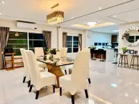 4 Bedroom House for Sale at Central Park Hillside open-plan dining area with chandelier and kitchen bar