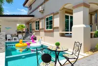 4 Bedroom House for Sale at Central Park Hillside poolside patio with pool floats and outdoor seating area