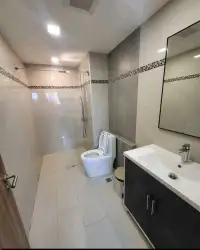 1 Bedroom Condo for Sale at Laguna Beach Resort 3 (The Maldives) bathroom with glass shower, toilet and dark vanity sink