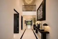 5 Bedroom House for Sale at Highgrove Villas marble-floored hallway with double-height ceiling and chandelier