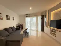 2 Bedroom Condo for Rent at Pattaya Heights living area with city view balcony, TV unit and marble accent wall
