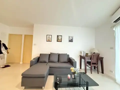 2 Bedroom Condo for Rent at Pattaya Heights lounge with sofa, study desk and wall art near bedroom doors