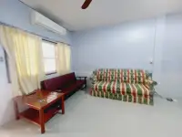 2 Bedroom House for Rent in Central Pattaya living room with striped sofas and wooden coffee table
