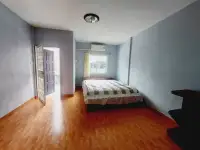 2 Bedroom House for Rent in Central Pattaya bedroom with double bed, wood flooring and balcony door